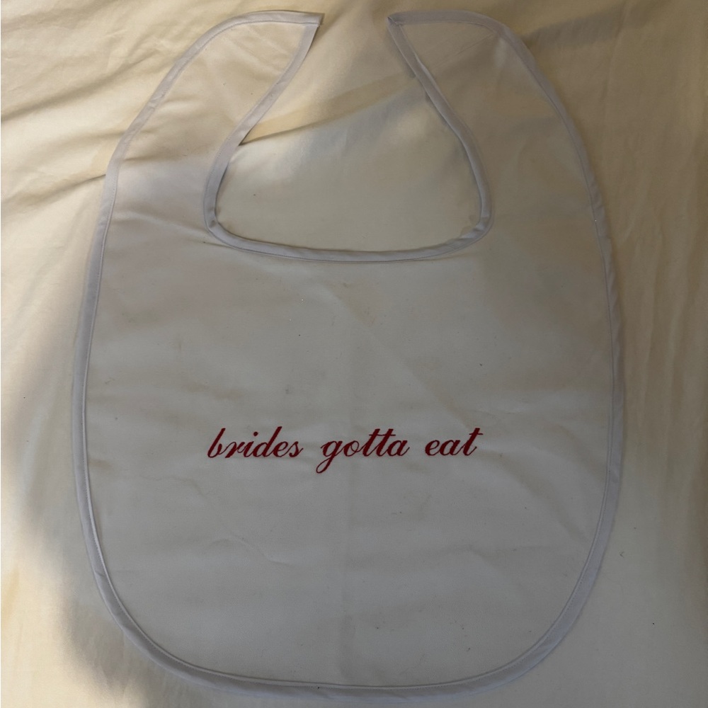 White Bib with Red "brides gotta eat" Script